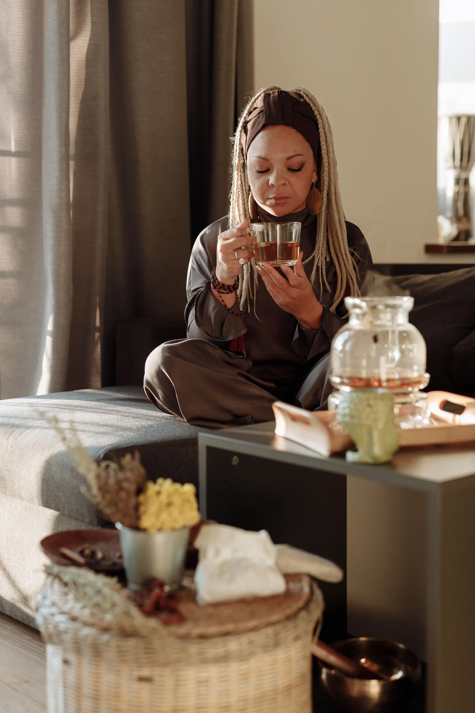 A woman relaxing with a warm cup of tea in a peaceful living space