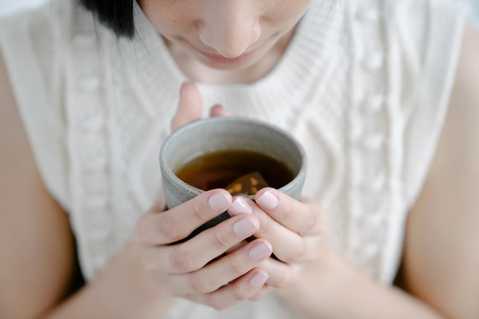 A calm wellness moment with aromatic herbal tea in a ceramic cup